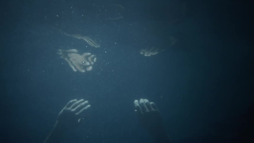 Two hands underwater are reflecting on the surface