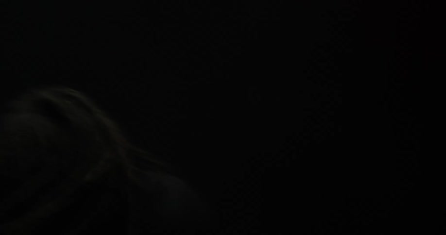 A man in a room dancing with a black background