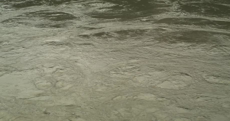The surface of the water swirls and ripples