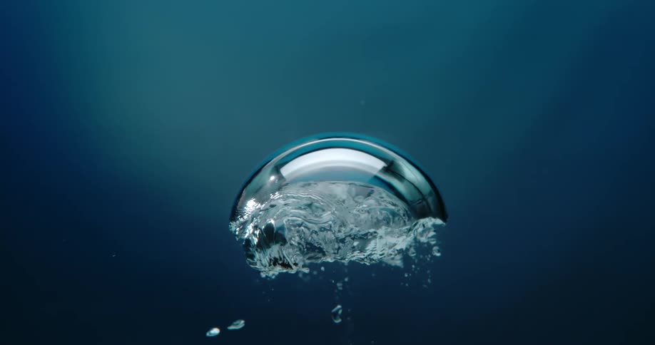 Bubbles underwater are slowly rising to the top
