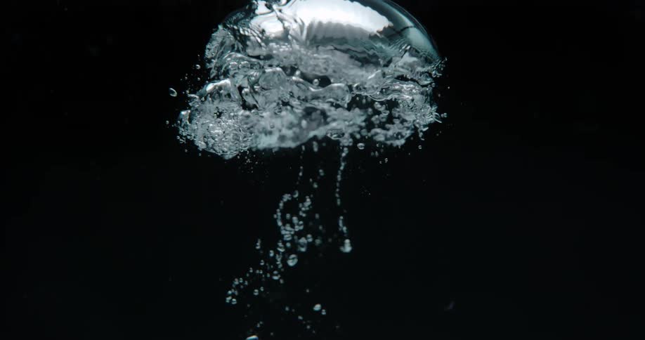 Surreal footage of a large bubbling rising up followed by little bubbles