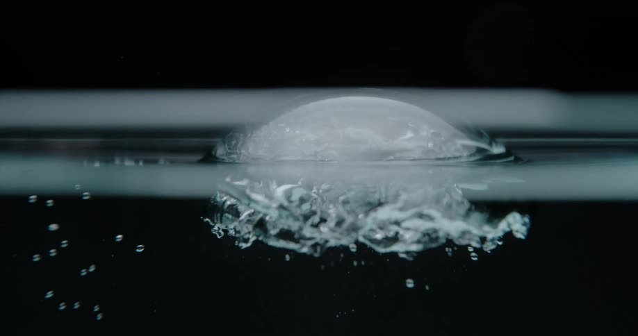 A large bubble reaches the surface as it pops