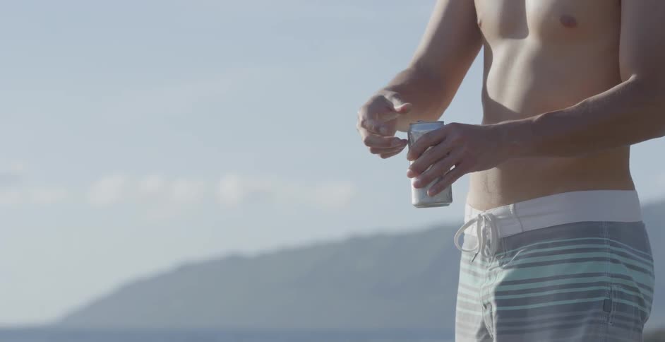 A man opens a can on a cloudy day