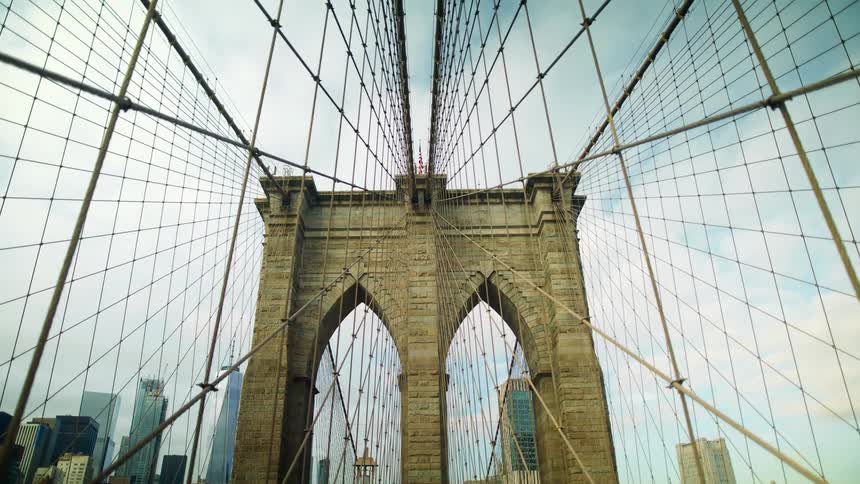 Netting surrounds a bridge that leads to a downtown city