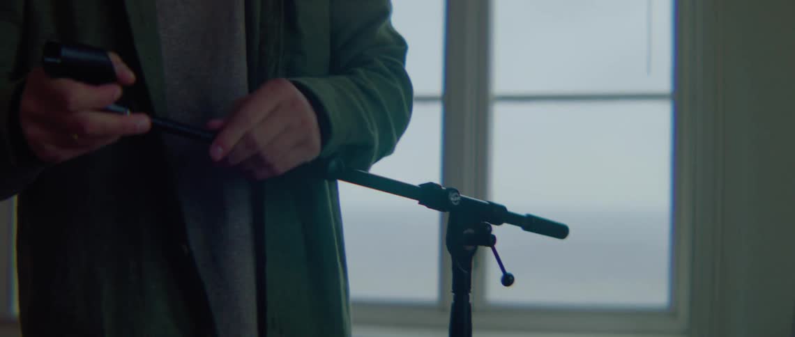 A man setting up a stand in a room