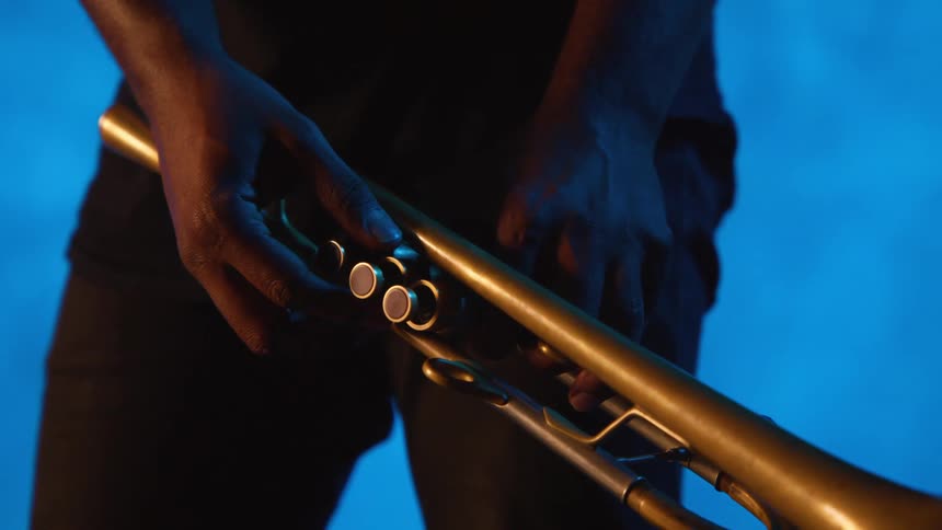 A person is tuning his trumpet