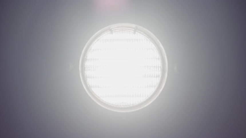 A lamp is used as a video transition effect going from darkness to completely white