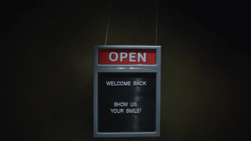 An open sign for a business suspended in fog