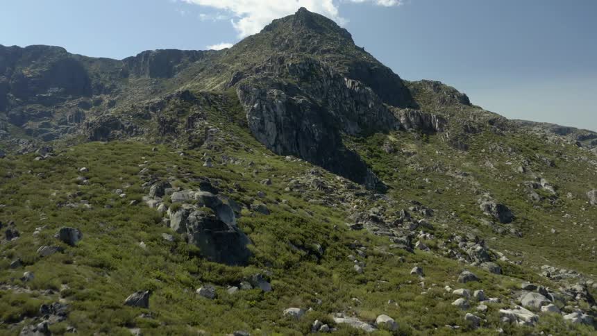 Rock covered mountain ridge high in a cloudy sky