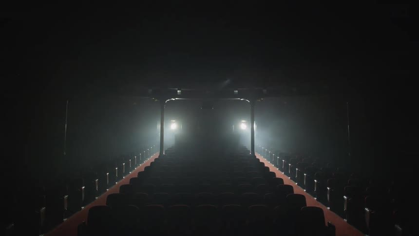 Lights are turned on and off in an empty theater