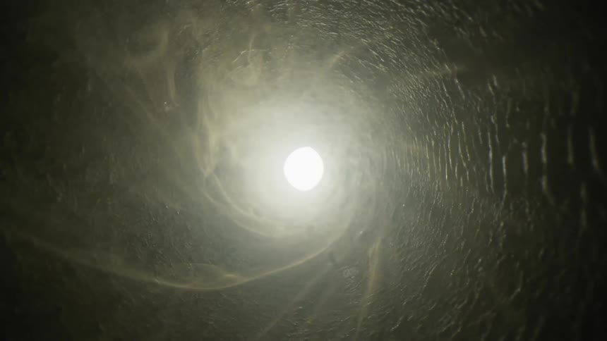 Gray black and white colors that look like inside a pipe with smoke
