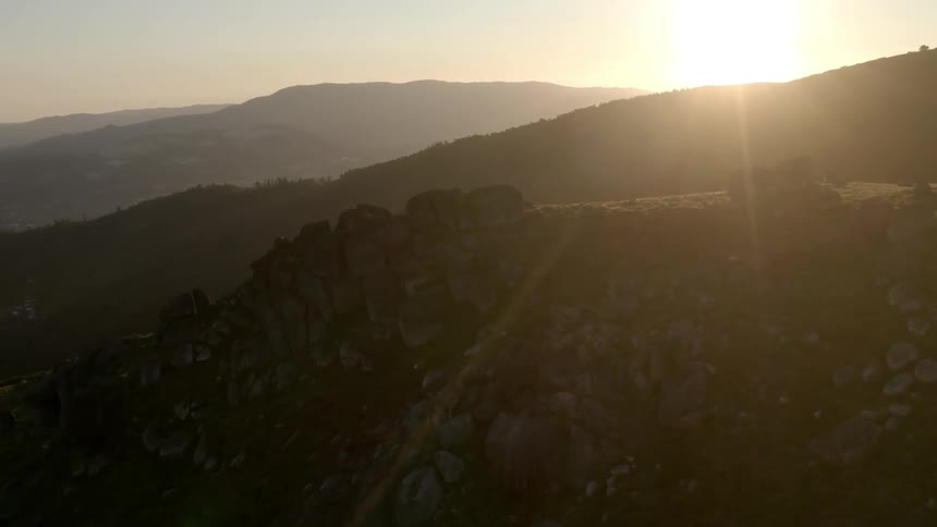 The sun is rising on the mountain range