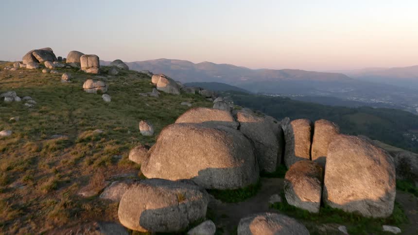 The large mountain is covered with boulders