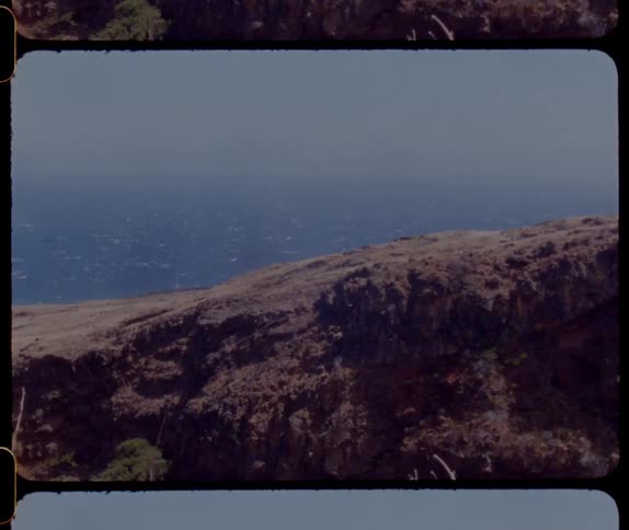 A rocky shore with the ocean sky and clouds in the background