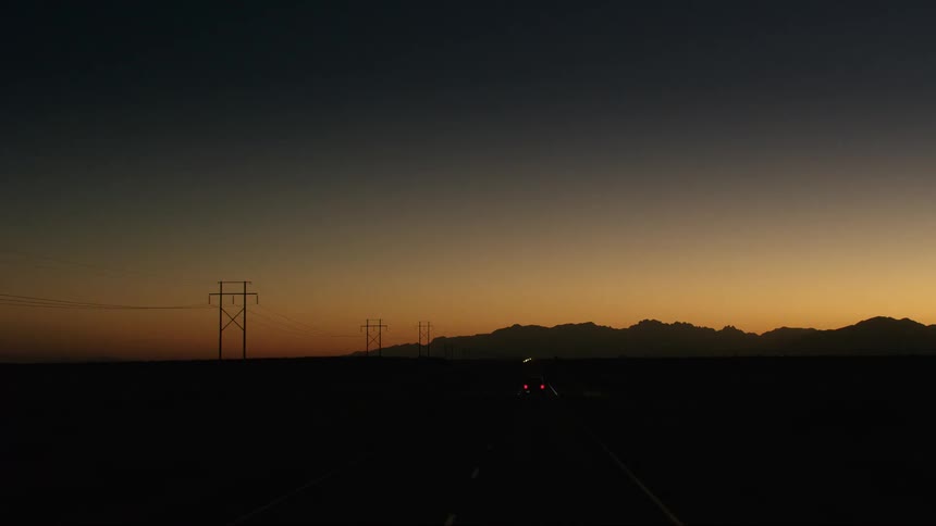 A view of a car driving outdoors on a road