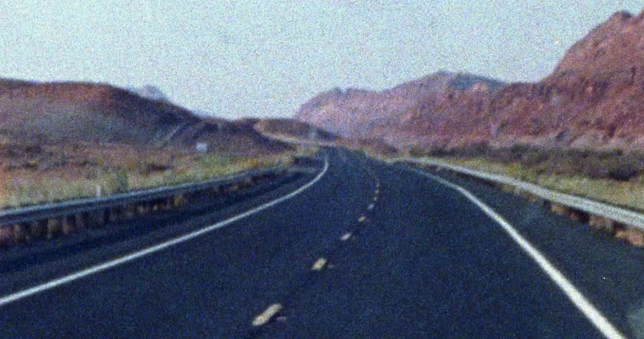 The highway is empty going through the mountain range