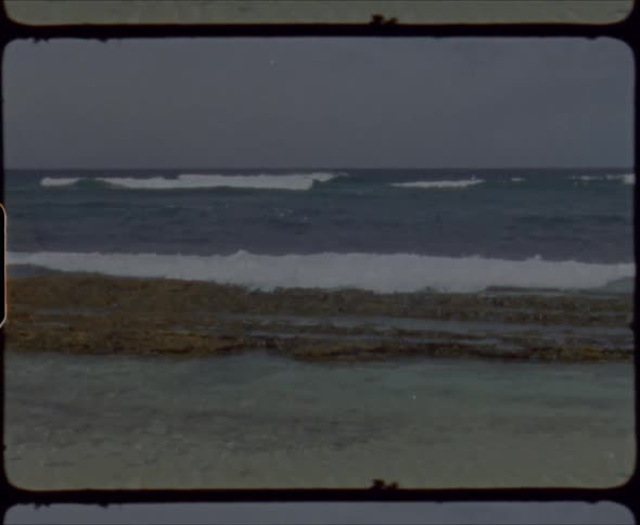 Waves are crashing against a break wall and rolling over it