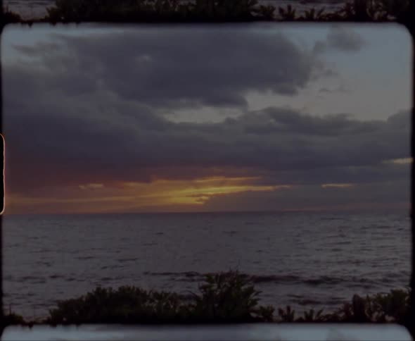The sun is setting on the beach