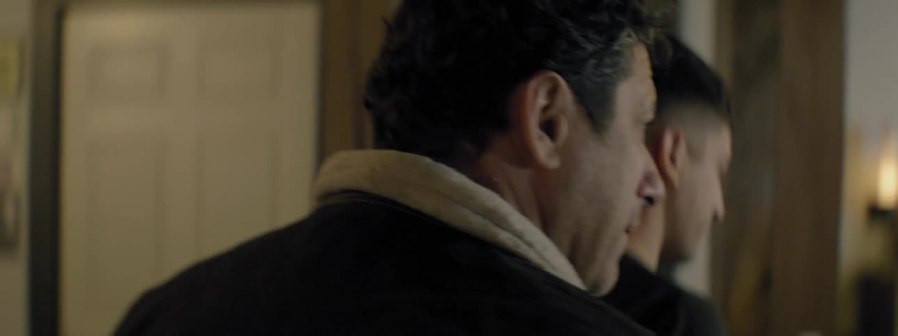 Two men walking through a house