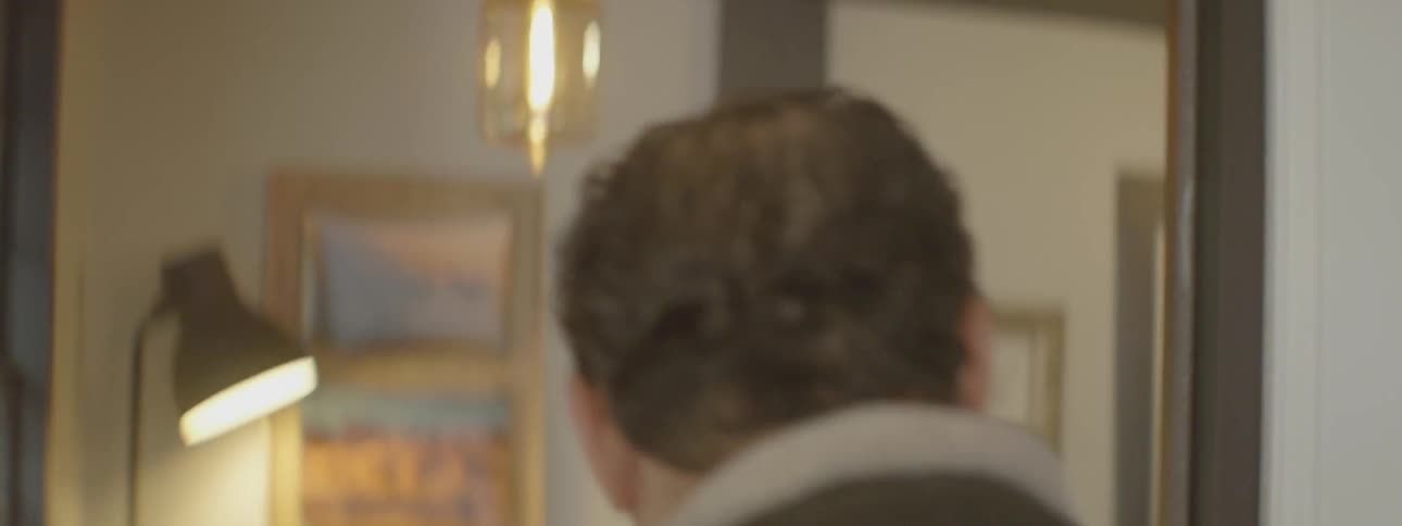 A man walks and enters a glass door