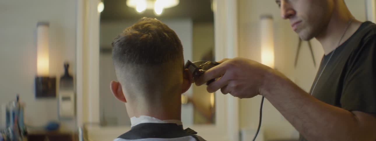 A barber trims a man's hair