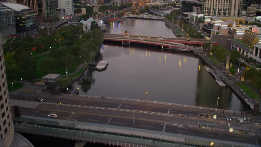 Traffic bridges spanning a river through a metropolis in the evening