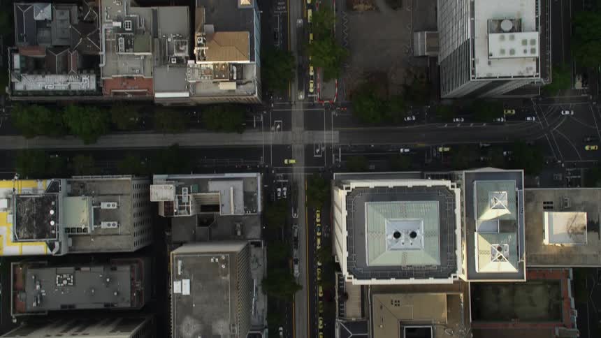 An aerial view looking straight down onto the downtown district of a metropolis during the daytime
