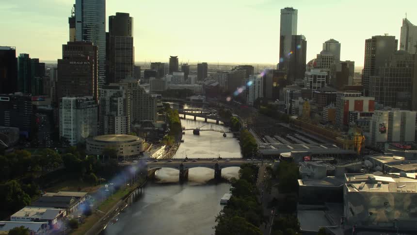 Bridges spanning a river through a metropolis during the day