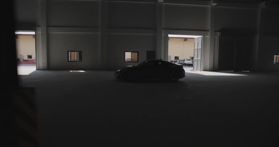A car drives through the hangar