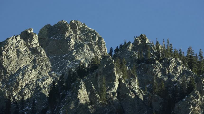 A view of a mountain range with trees on it