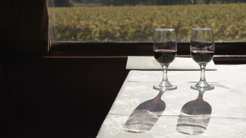 A train with a table with two glasses of wine on it