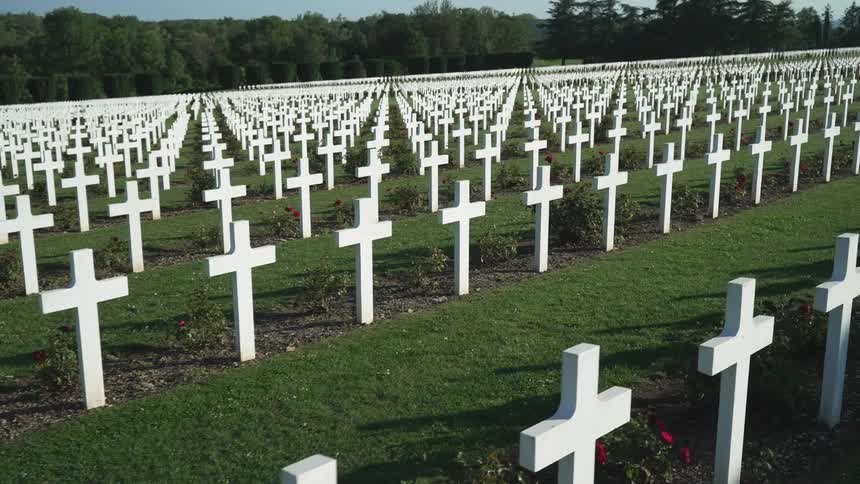 A lot of white cemetery crosses on the grave