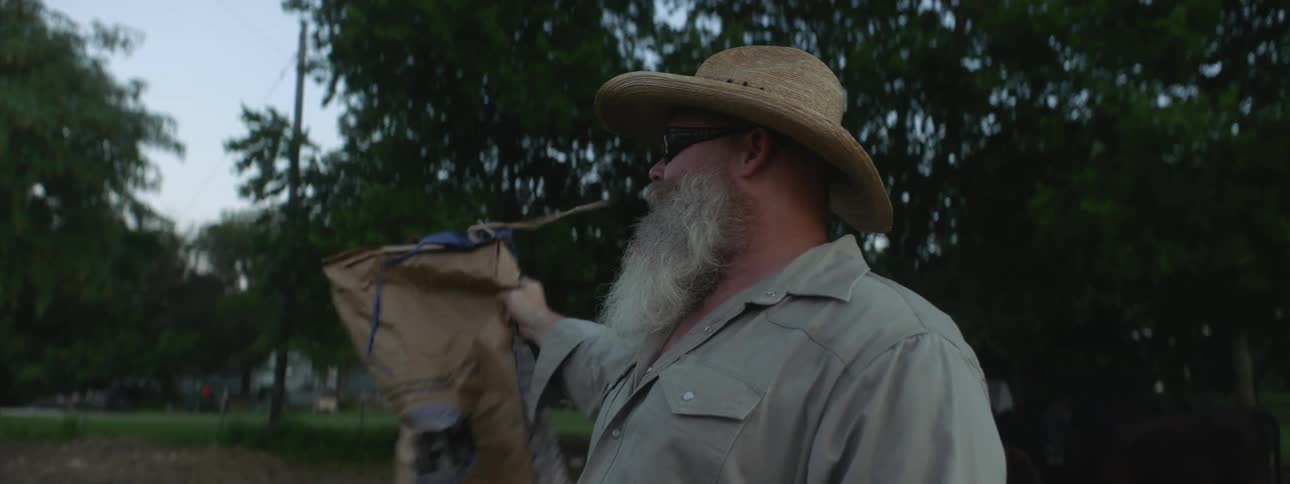 A man calls for someone and shakes a bag