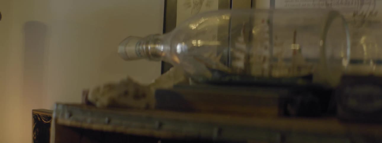 A bottle has a small boat inside
