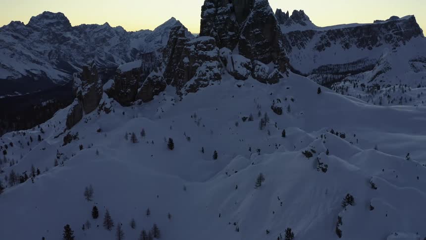 Snow covered forest and mountain range under clear sky