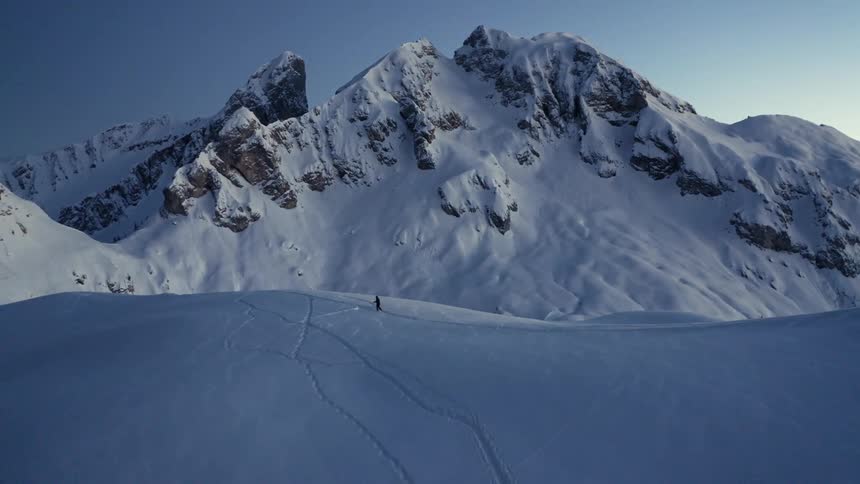 Person walking on snowy mountain