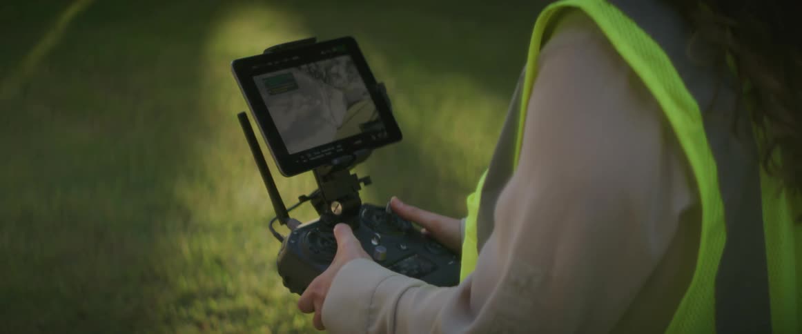 A woman with a vest and controller