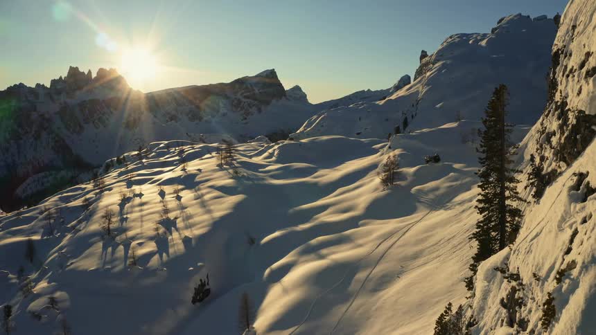 A snowy mountainside in the wilderness on a sunny winter morning