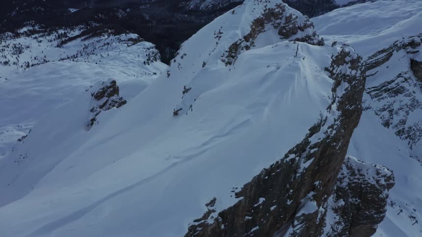 An aerial view of a mountain top covered in snow