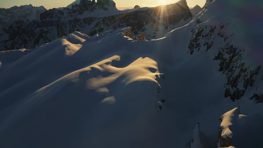 The sun is rising on the mountain range