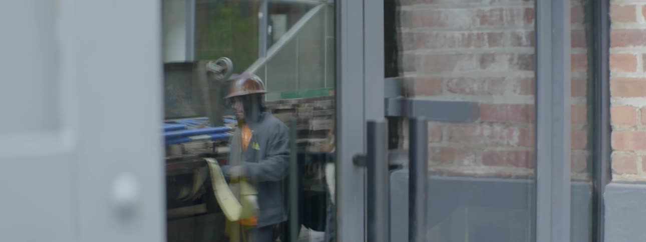 People are reflected in a window