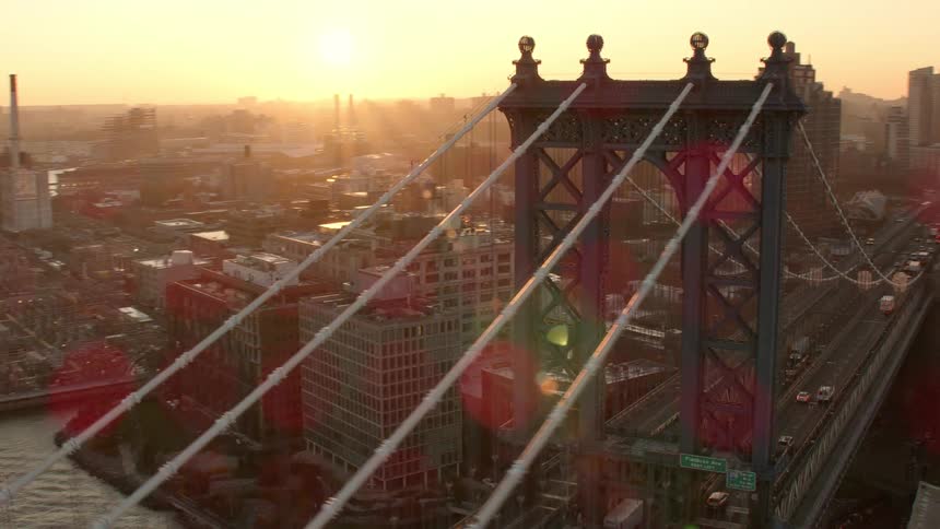 Vehicles drive over the bridge through the city