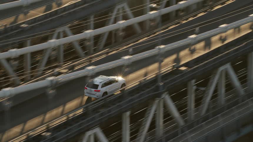 Cars bridge onto overpass through city