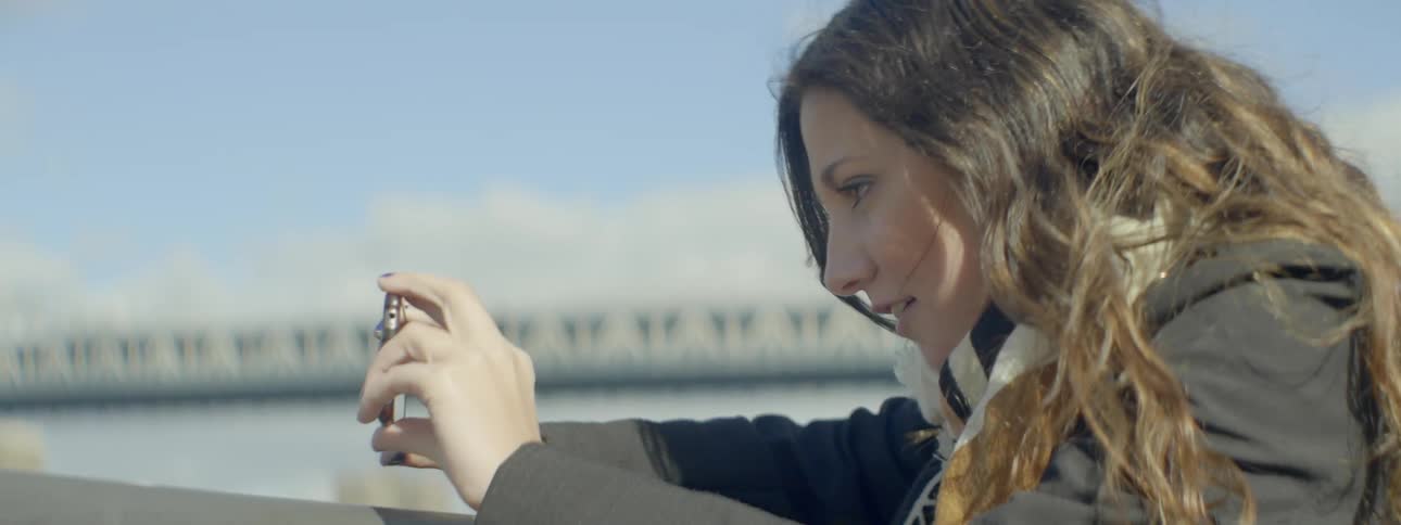 A woman takes pictures outdoors