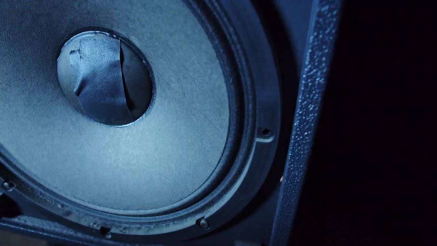 A strobe light is flashing onto an audio speaker