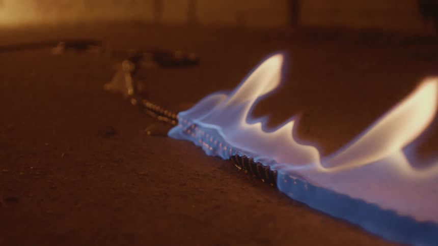 The fire is slowly moving through the rope on the ground