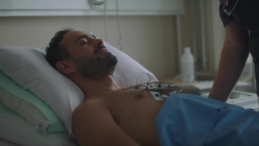 A man laying in a hospital bed
