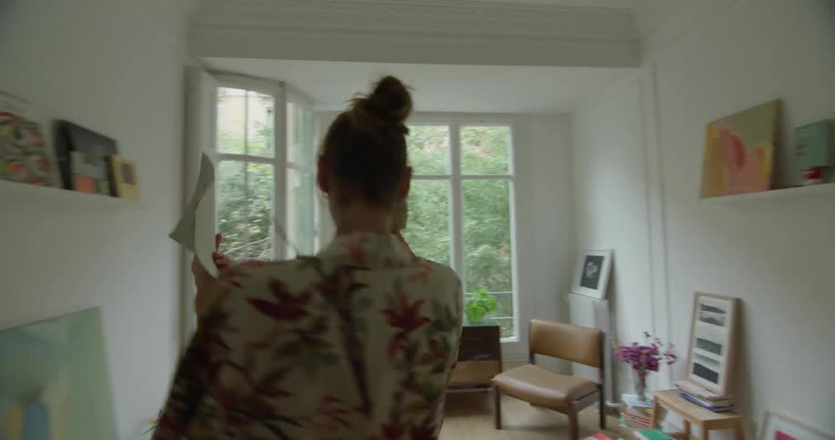 Man plays the violin for a laughing young woman on a room at home