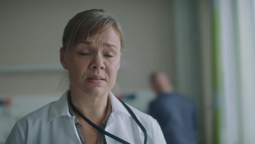 A doctor in a hospital delivers bad news