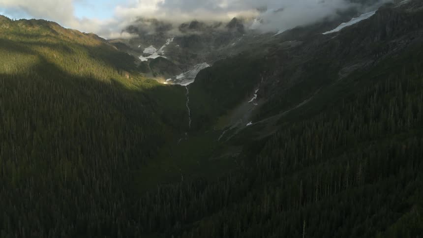 Tilt up reveal of a beautiful and majestic mountain valley